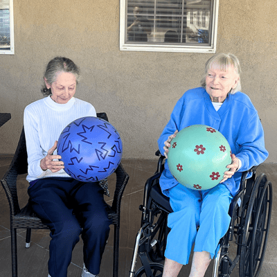 Two residents participating in an activity outdoors