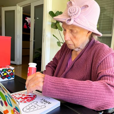 Elderly resident engaging in a coloring activity