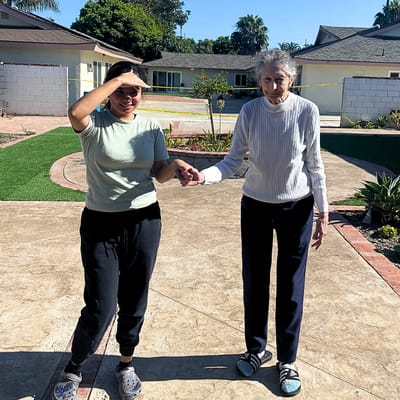 A caregiver assisting a resident outdoors