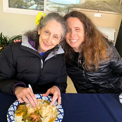 Two residents enjoying a meal together with smiles