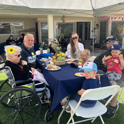 Residents enjoying a meal outside during a group event