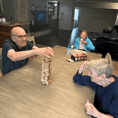 Residents playing Jenga in a common area