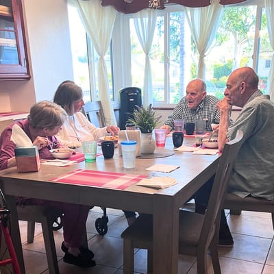 Residents enjoying a meal together at a dining table