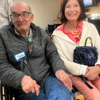 Two residents smiling in a cozy indoor setting