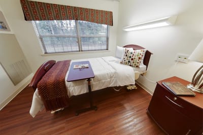 Cozy resident room with a bed and desk