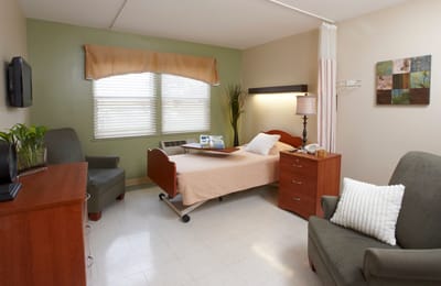 Cozy private resident room with bed and seating
