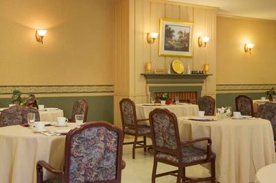 Dining area set for residents with floral decor