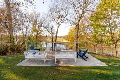 Outdoor seating area by a tranquil water view