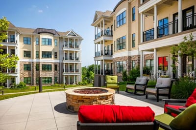 Outdoor seating area with fire pit and greenery