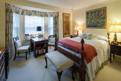 A cozy private room with floral decor and desk