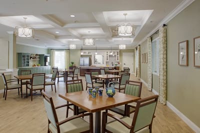 Bright dining room with tables and chairs for residents
