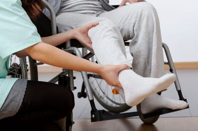 Caregiver assisting resident in a wheelchair