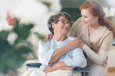 Staff member engaging with a resident in a cozy setting