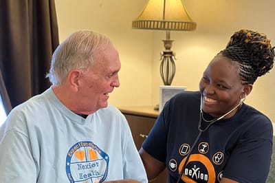 Staff member engaging with a senior resident indoors