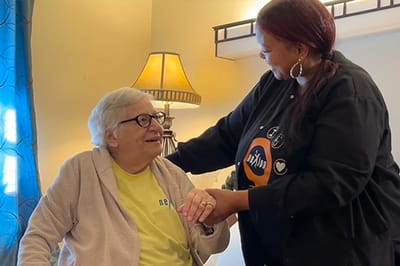 Staff member interacting with a resident in a cozy room
