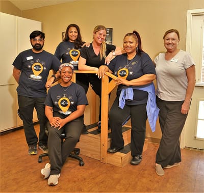 Staff members posing in a welcoming indoor area