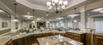 Bright common area with seating and decorative lighting