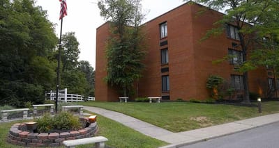 Exterior view of a senior living facility with gardens