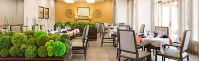 Elegant dining room with green decor and table settings