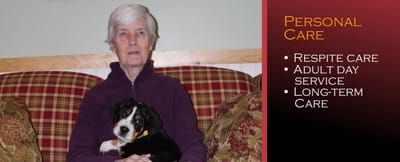 Resident sitting with a dog in a cozy lounge area