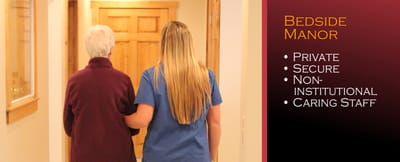 Staff assisting a resident in a hallway