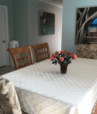 Dining area with a table and floral centerpiece