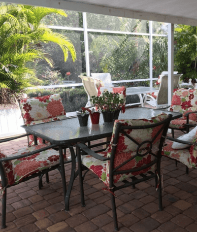 Outdoor seating area with floral cushions and plants