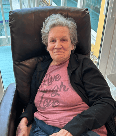 Senior woman smiling in a comfortable chair
