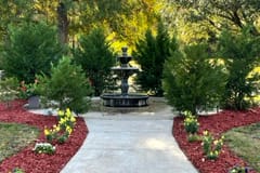 Chadwick Community Care Center, nursing home in Jackson, MS — Garden path leading to a decorative fountain