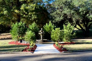 Chadwick Community Care Center, nursing home in Jackson, MS — Garden pathway featuring a decorative fountain and shrubs