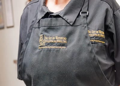 Close-up of caregiver apron with logo