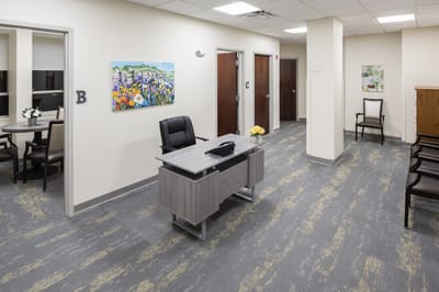 Modern reception area with a desk and artwork
