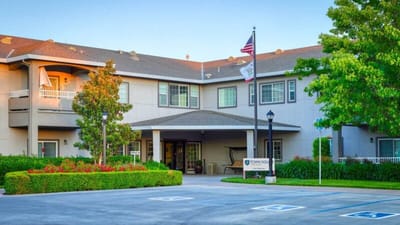 Exterior view of a senior living facility with landscaped entrance
