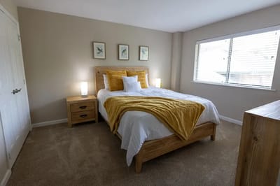 Cozy bedroom setup with a yellow throw blanket