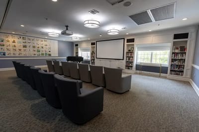 Bright common area with seating and bookshelves