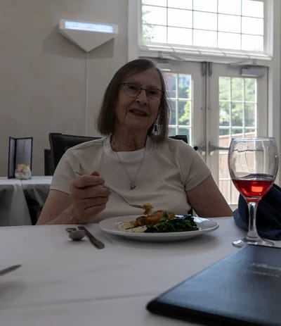 A resident enjoying a meal in the dining area