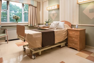 A well-furnished resident room with a bed and decorations