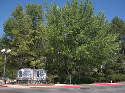 Outdoor signage for the facility surrounded by trees