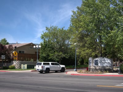 Exterior view of the facility with landscaping and vehicle