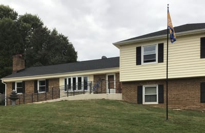 Exterior view of Russell Residence with a flag.