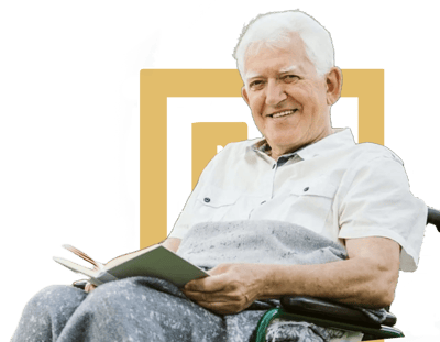 Smiling older man reading in a wheelchair