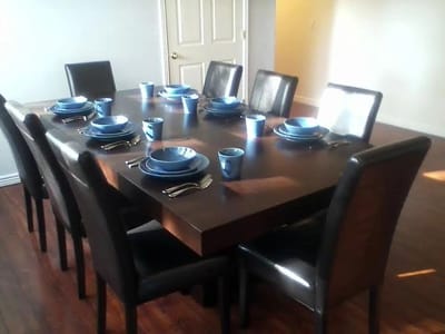 Dining table set with blue plates and cups