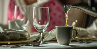 Coffee being poured into a cup at a dining table