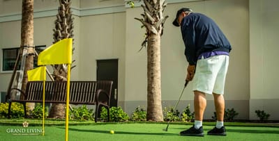 Resident playing golf on a manicured green