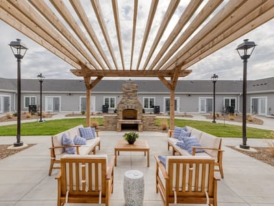 Outdoor seating area with a fireplace and landscaping