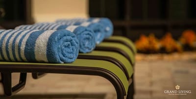 Close-up of rolled towels on a lounge chair by the pool