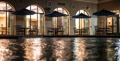 Outdoor dining area with umbrellas by a pool
