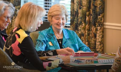 Residents playing a game in a brightly lit common area