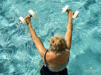 Senior resident exercising in a pool with weights