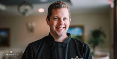 Chef smiling in a kitchen setting